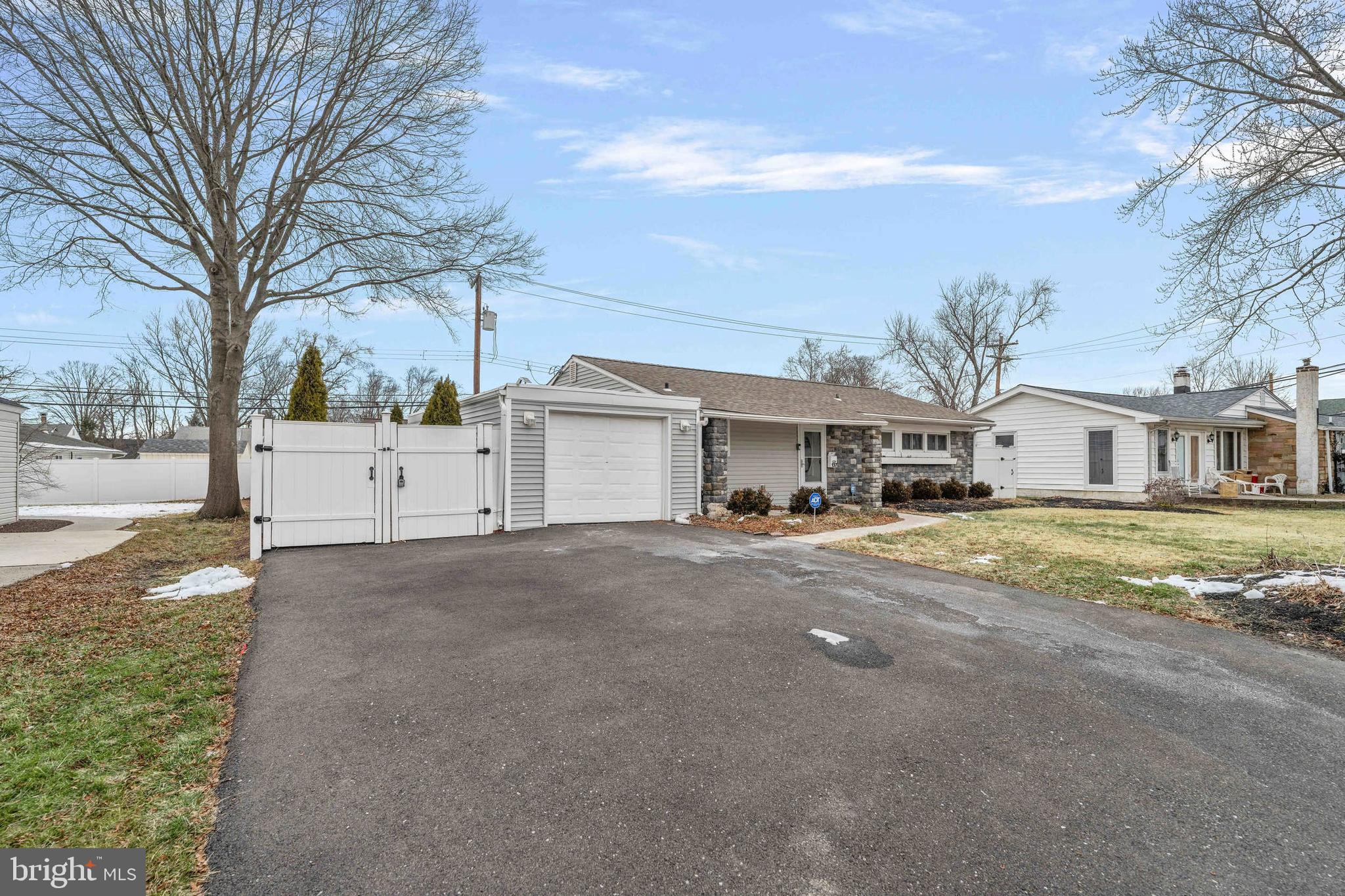 137 Idlewild Road Levittown, PA 19057 - Photo 2 of 34 a front view of a house with a yard and garage