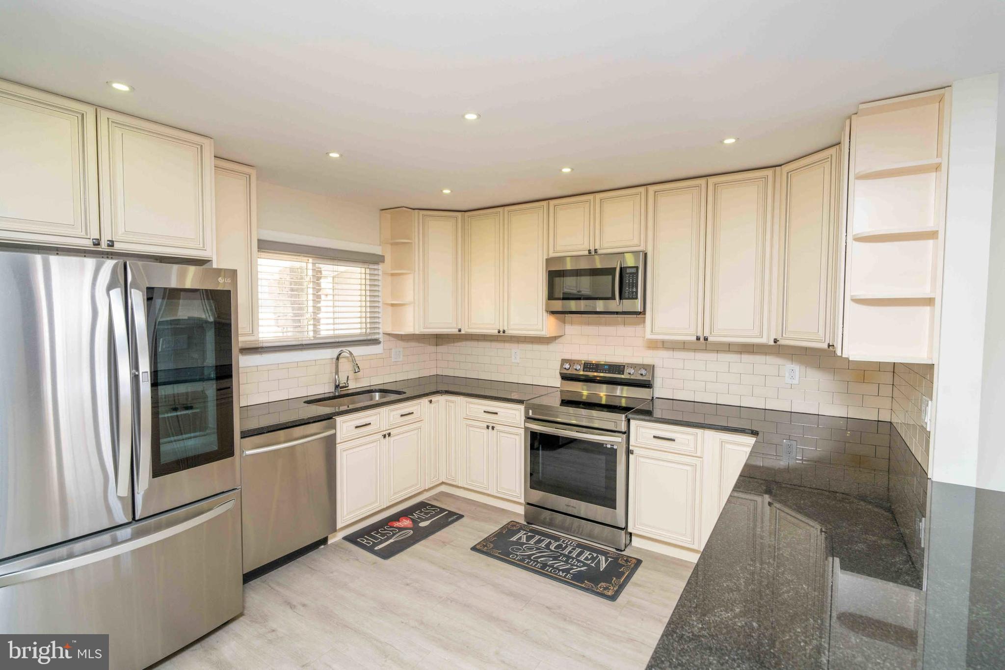 137 Idlewild Road Levittown, PA 19057 - Photo 4 of 34 a kitchen with granite countertop a refrigerator stove and sink