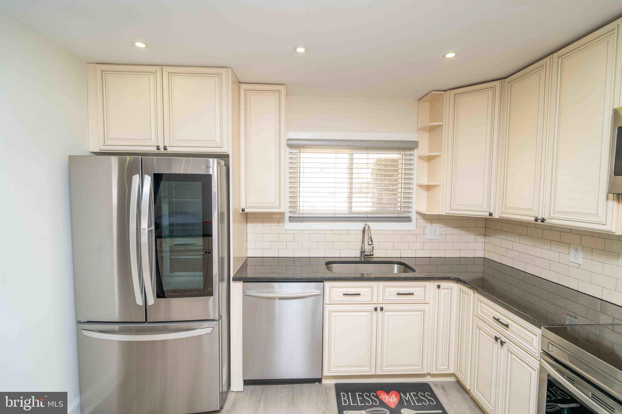 137 Idlewild Road Levittown, PA 19057 - Photo 6 of 34 a kitchen with kitchen island granite countertop appliances cabinets and a sink