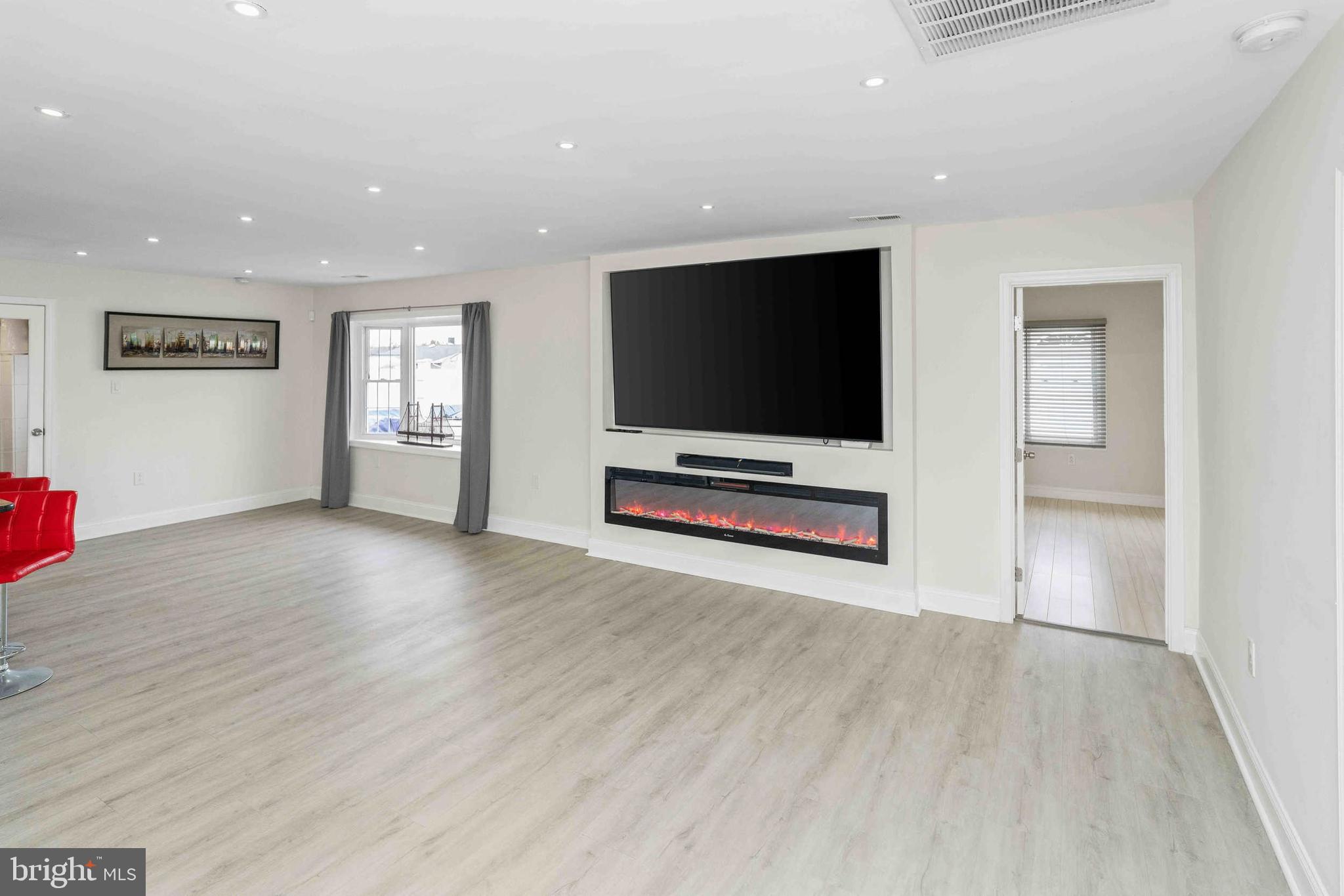 137 Idlewild Road Levittown, PA 19057 - Photo 8 of 34 a view of a livingroom with wooden floor and a flat screen tv