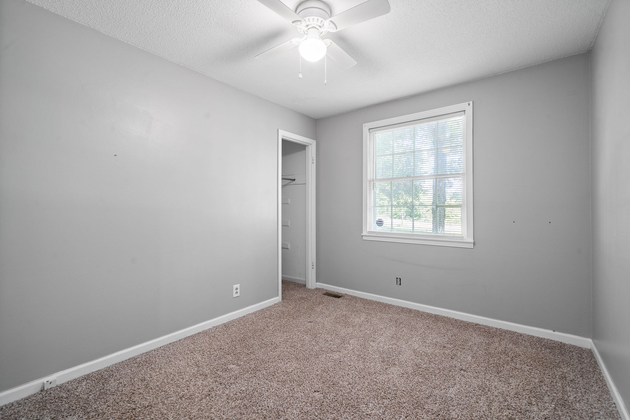 1024 Gratton Road Clarksville, TN 37043 - Photo 18 of 28 an empty room with a chandelier fan and windows