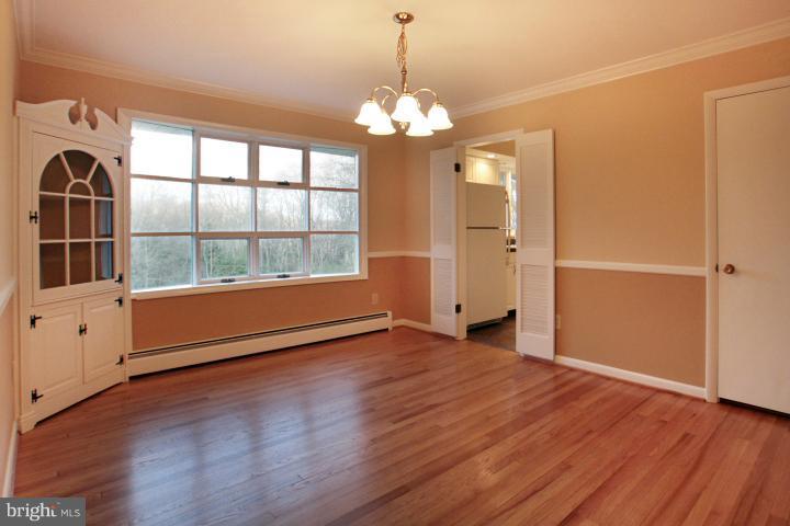 21315 Middletown Road Freeland, MD 21053 - Photo 2 of 30 a view of an empty room with wooden floor and a window