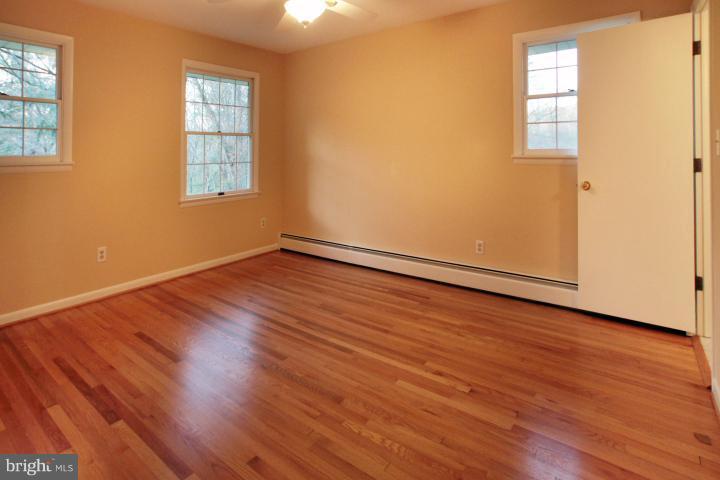 21315 Middletown Road Freeland, MD 21053 - Photo 11 of 30 an empty room with wooden floor and windows