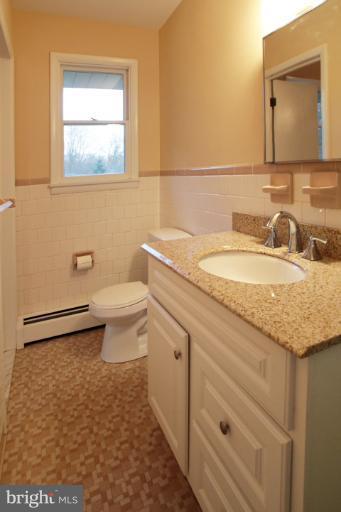 21315 Middletown Road Freeland, MD 21053 - Photo 12 of 30 a bathroom with a granite countertop sink a toilet and a mirror