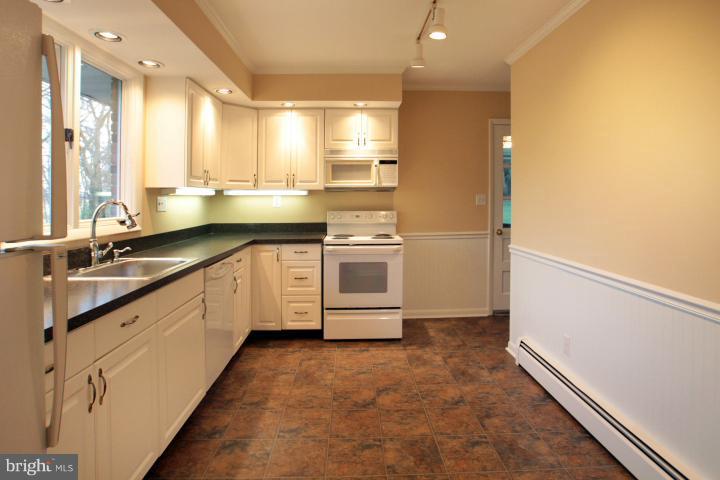 21315 Middletown Road Freeland, MD 21053 - Photo 17 of 30 a kitchen with stainless steel appliances granite countertop a sink a stove and a refrigerator