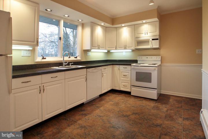 21315 Middletown Road Freeland, MD 21053 - Photo 22 of 30 a kitchen with stainless steel appliances granite countertop a sink and a white cabinets
