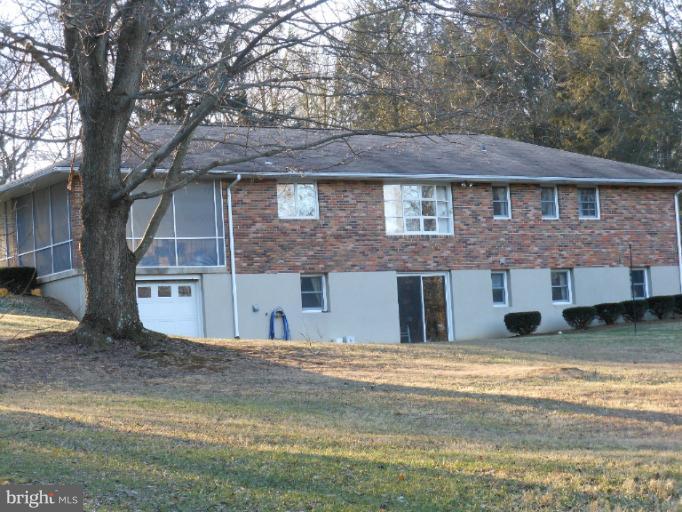 21315 Middletown Road Freeland, MD 21053 - Photo 29 of 30 a view of a brick house with large windows and a yard