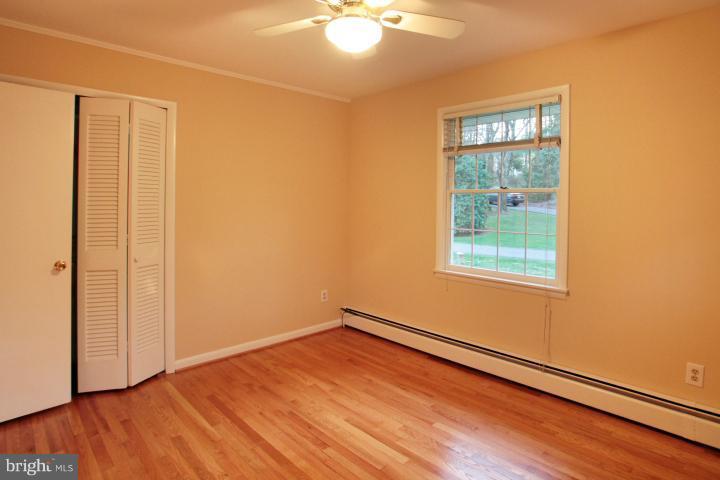 21315 Middletown Road Freeland, MD 21053 - Photo 6 of 30 an empty room with wooden floor and windows