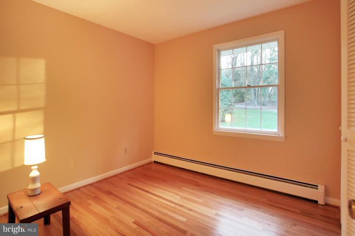 21315 Middletown Road Freeland, MD 21053 - Photo 10 of 30 an empty room with wooden floor and windows