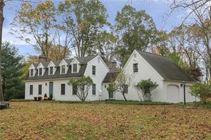 a view of a white house with a yard