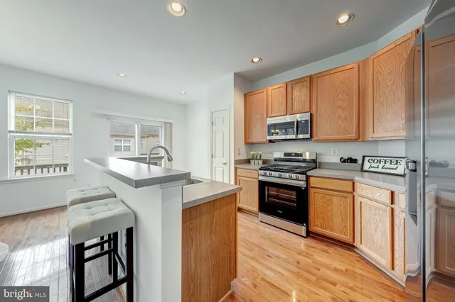 a kitchen with stainless steel appliances granite countertop a stove and a refrigerator