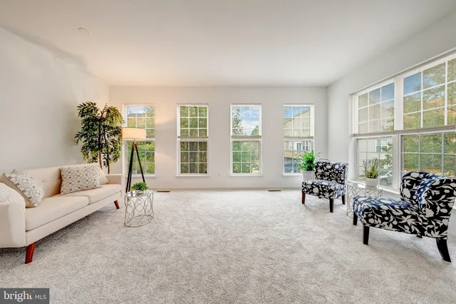 an empty room with furniture and windows