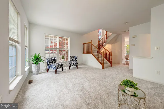 a kitchen with stainless steel appliances granite countertop a stove top oven a sink dishwasher and a refrigerator with wooden floor