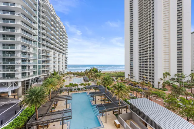 a view of a swimming pool with a lawn chairs