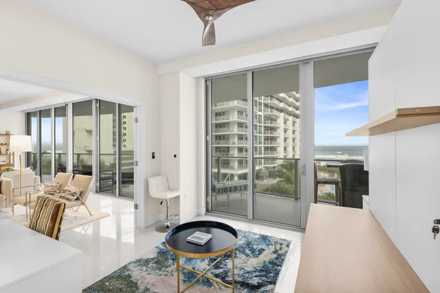 a bedroom with a bed and glass door