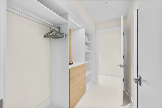 a spacious bedroom with a bed a couch and a window