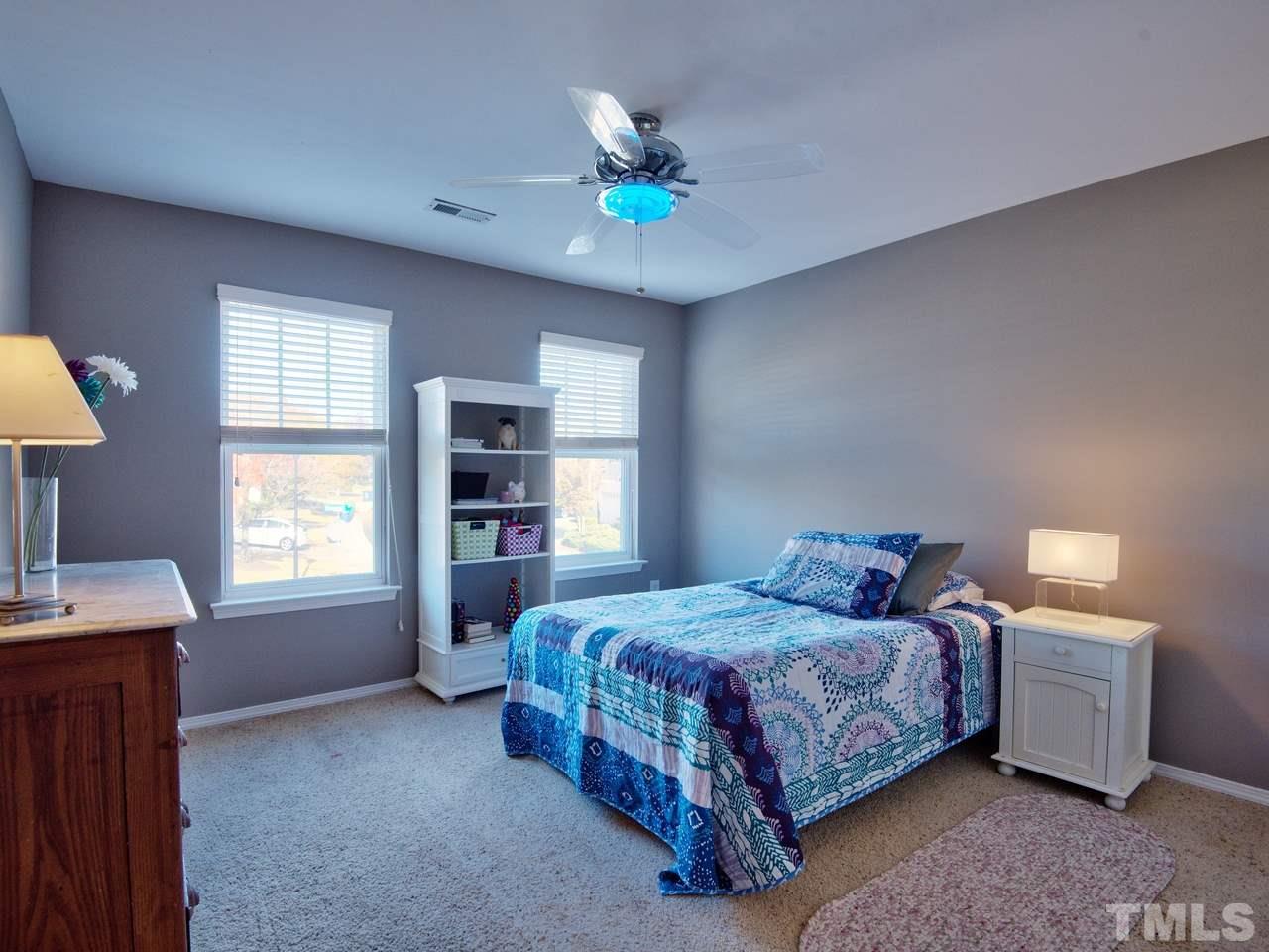8415 Stonework Drive Raleigh, NC 27613 - Photo 15 of 24 a bedroom with a bed and a window