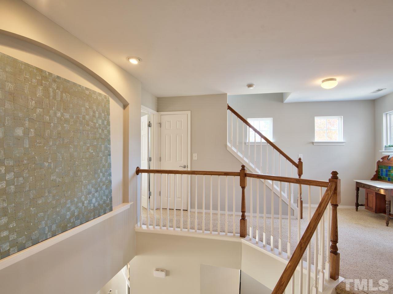 8415 Stonework Drive Raleigh, NC 27613 - Photo 16 of 24 a view of entryway with wooden floor