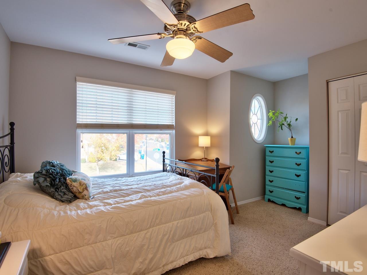 8415 Stonework Drive Raleigh, NC 27613 - Photo 17 of 24 a bedroom with a bed and a chandelier