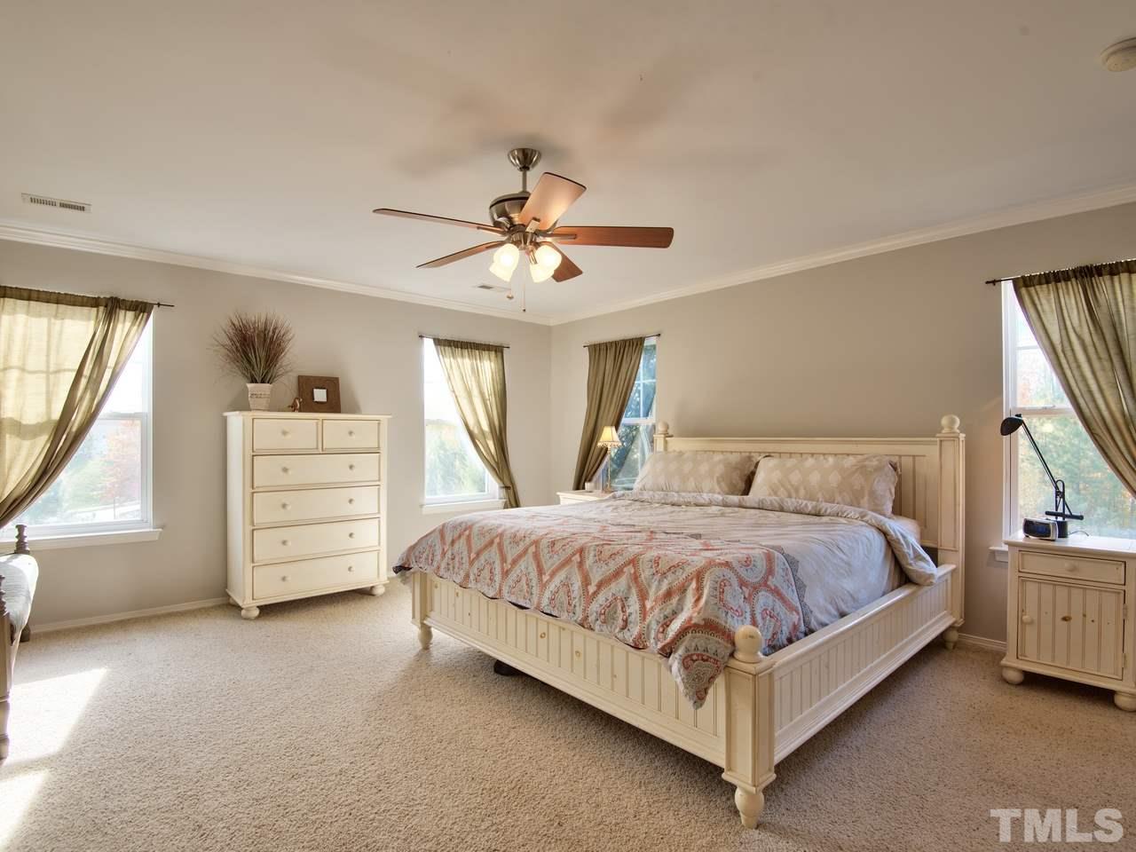 8415 Stonework Drive Raleigh, NC 27613 - Photo 21 of 24 a bedroom with a bed a dresser and a window
