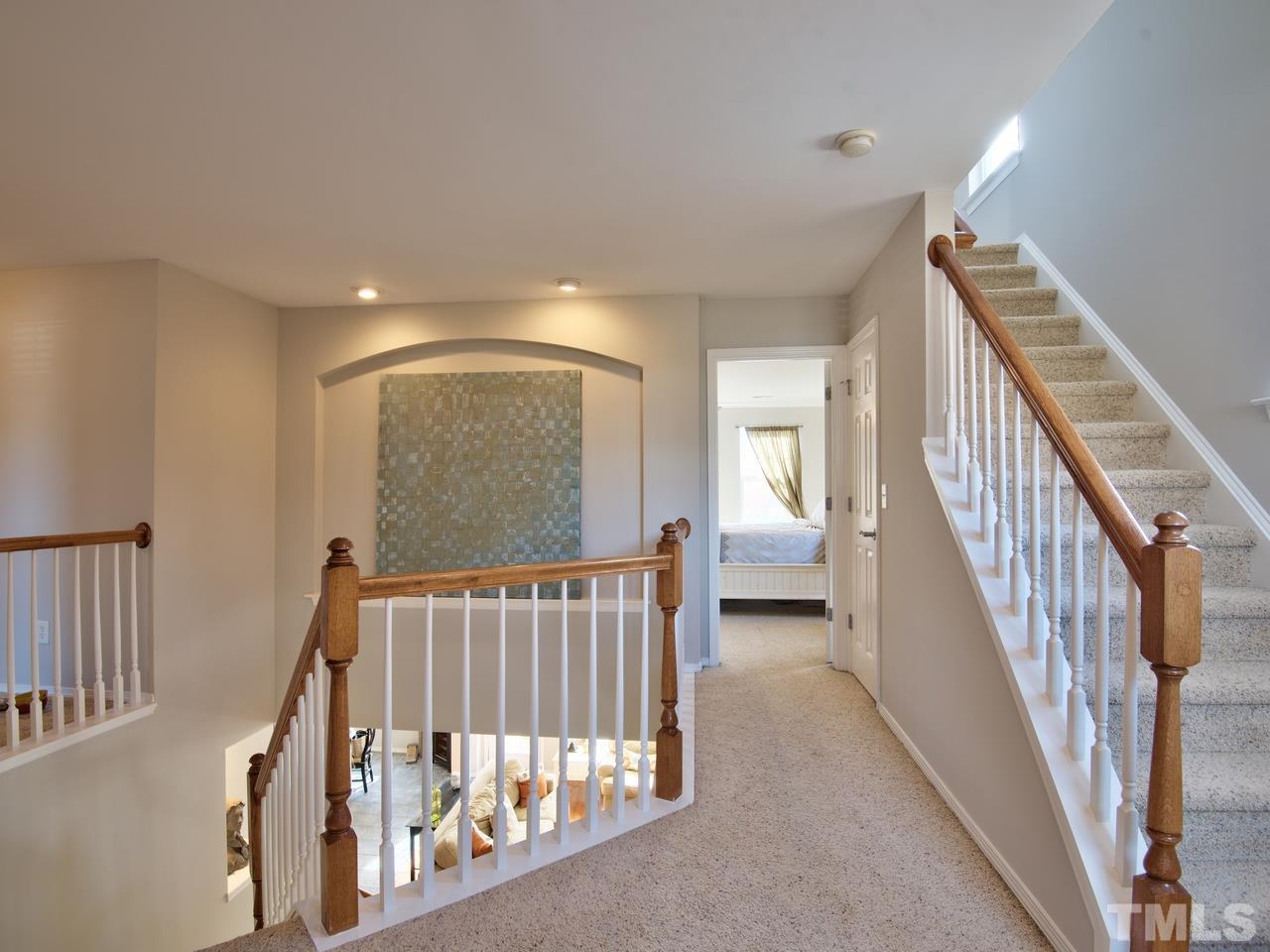 8415 Stonework Drive Raleigh, NC 27613 - Photo 22 of 24 a view of staircase with railing and white walls