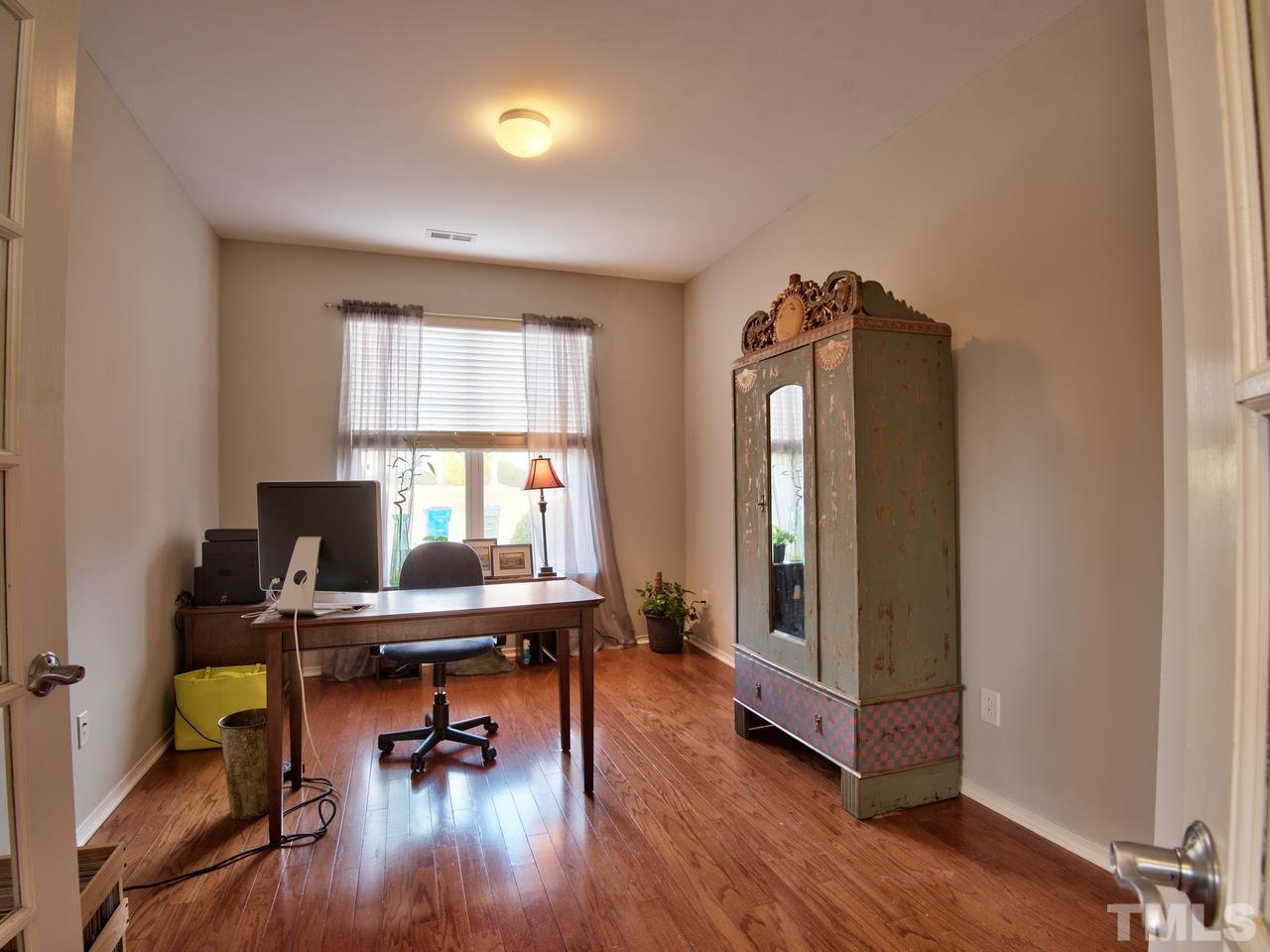 8415 Stonework Drive Raleigh, NC 27613 - Photo 5 of 24 a view of a workspace with furniture and a window