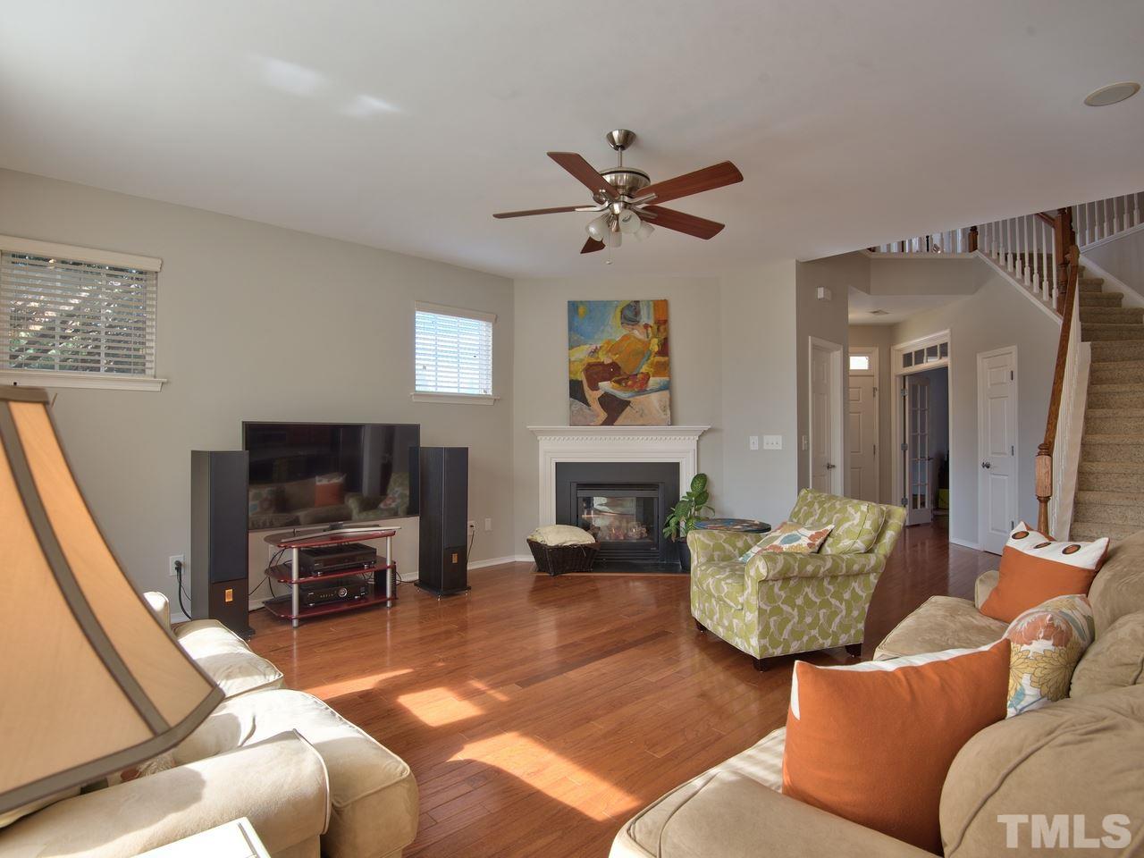 8415 Stonework Drive Raleigh, NC 27613 - Photo 8 of 24 a living room with furniture and a fireplace