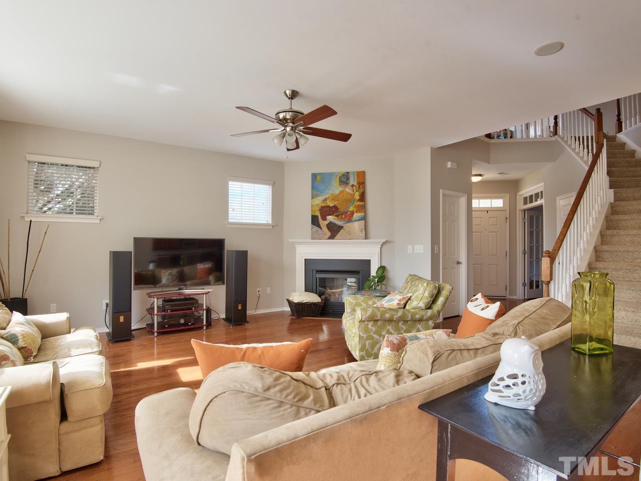 8415 Stonework Drive Raleigh, NC 27613 - Photo 9 of 24 a living room with furniture and a flat screen tv