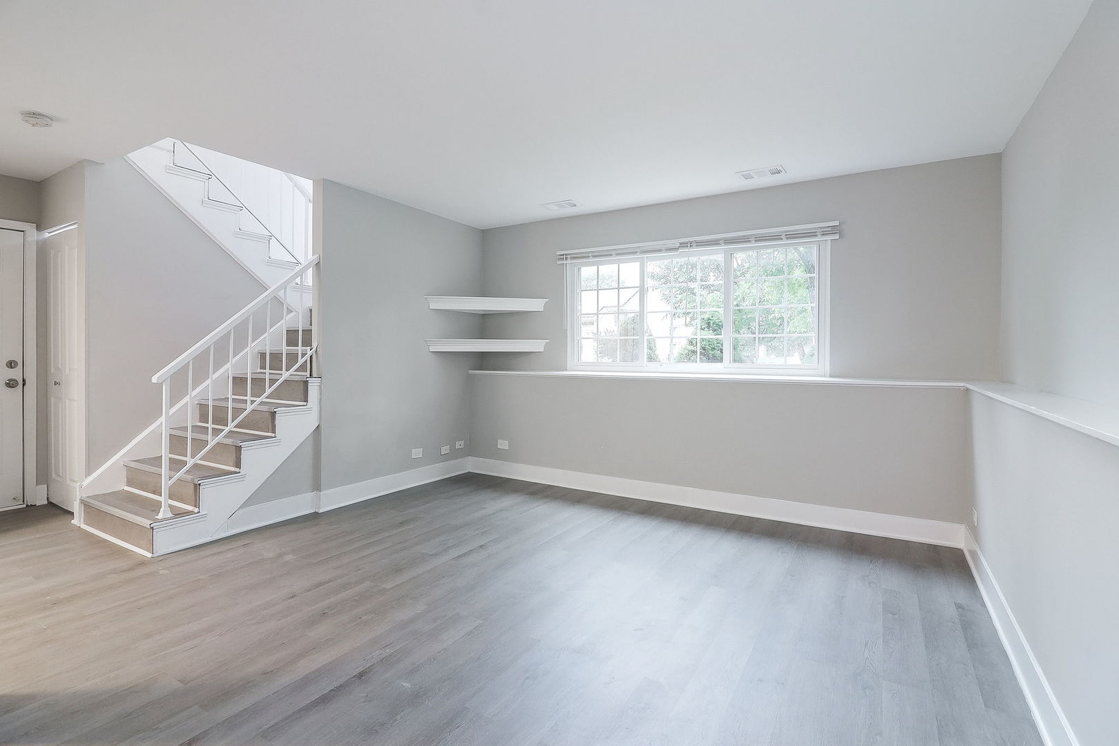 1914 Brookside Lane Hoffman Estates, IL 60169 - Photo 13 of 16 a view of an empty room with wooden floor and a window