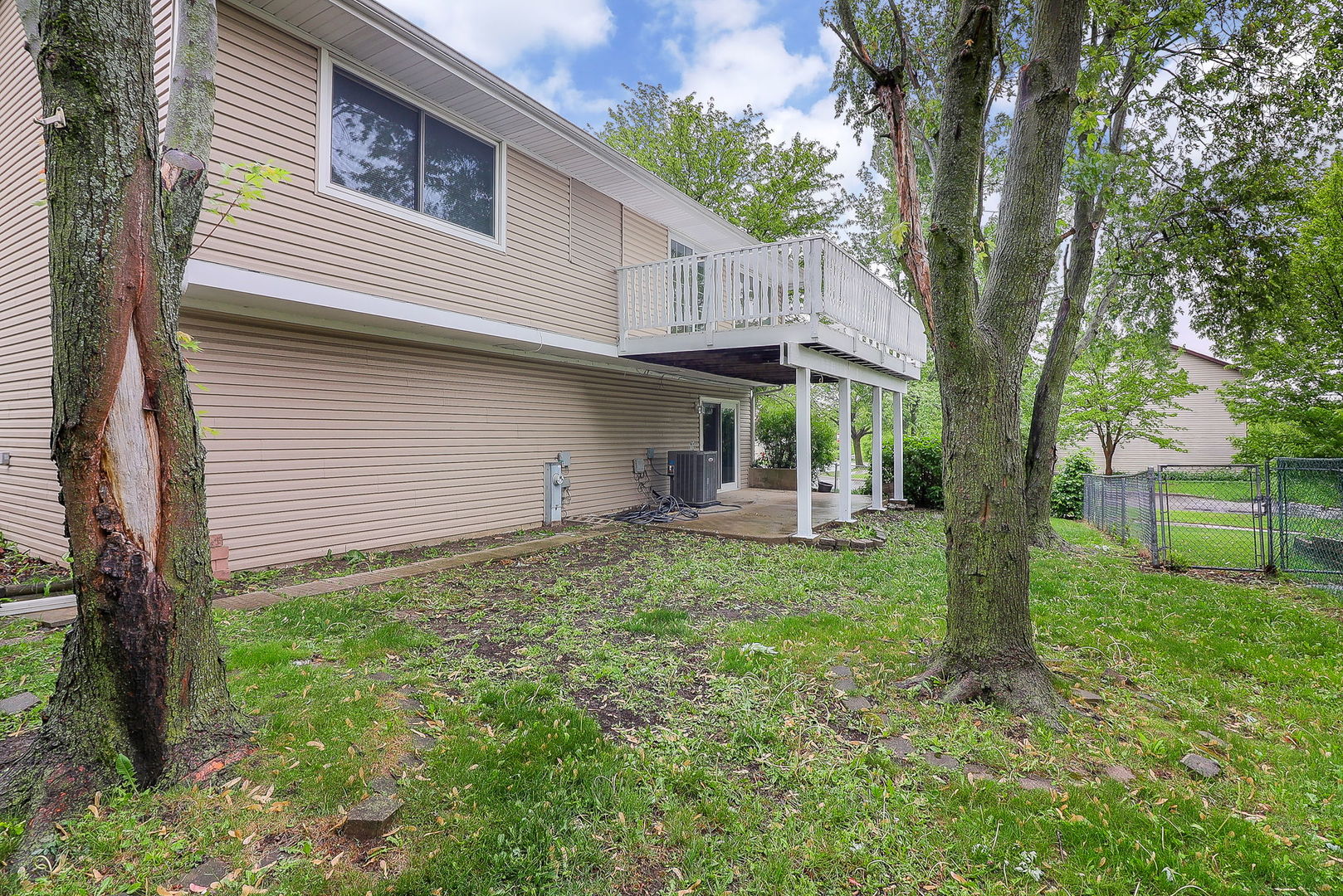 1914 Brookside Lane Hoffman Estates, IL 60169 - Photo 16 of 16 a view of a house with backyard and a tree