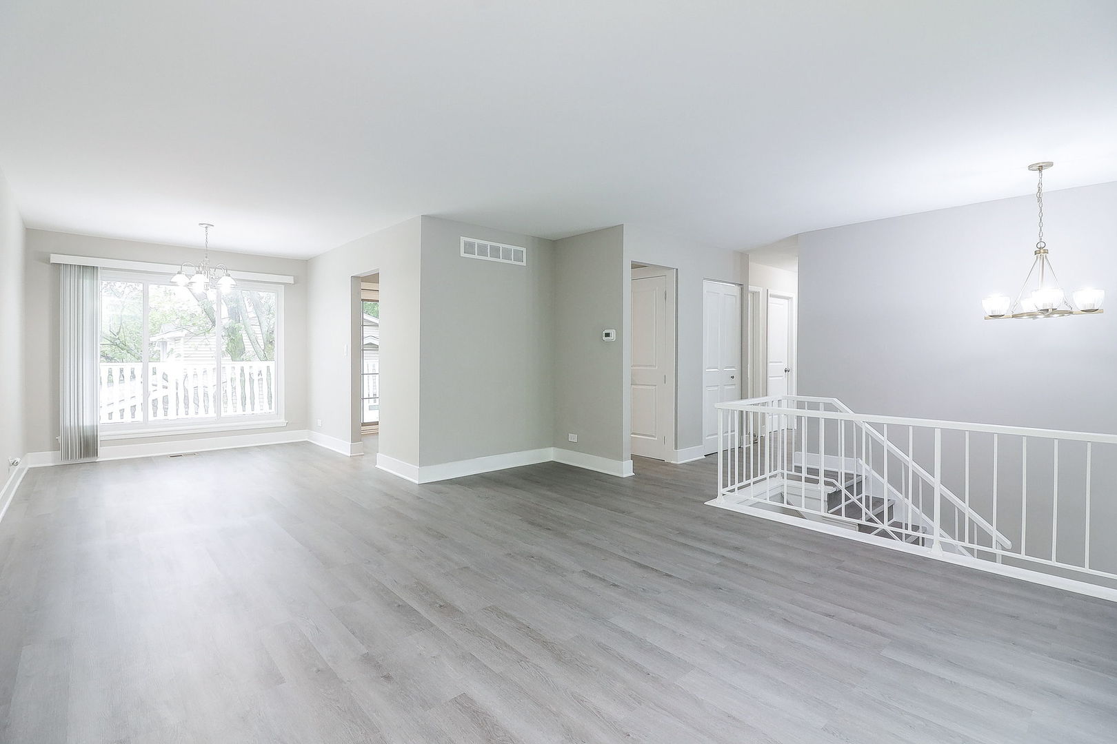 1914 Brookside Lane Hoffman Estates, IL 60169 - Photo 3 of 16 an empty room with wooden floor and windows