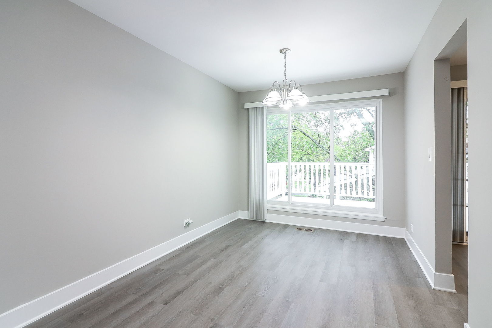 1914 Brookside Lane Hoffman Estates, IL 60169 - Photo 5 of 16 a view of an empty room with wooden floor and a window