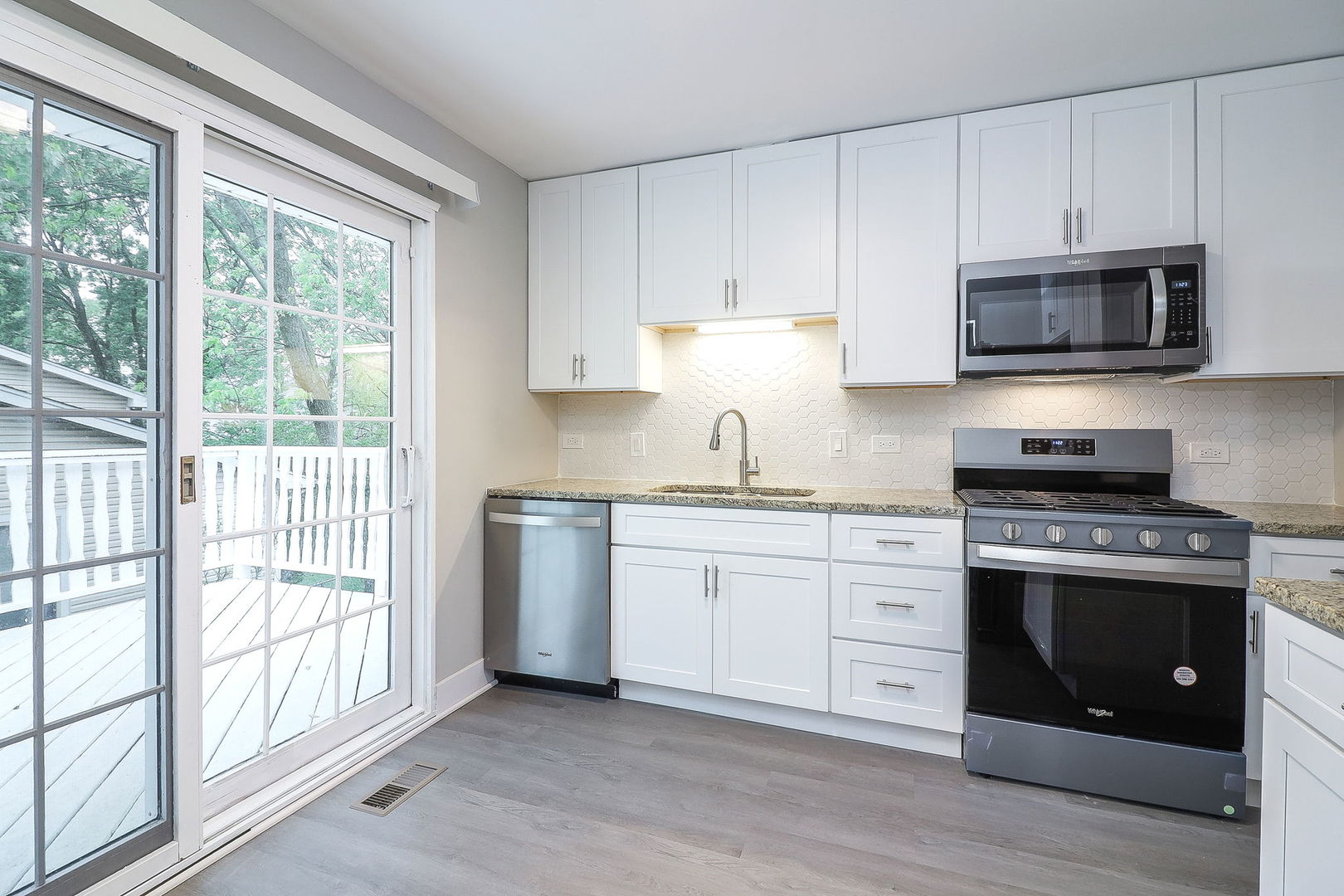 1914 Brookside Lane Hoffman Estates, IL 60169 - Photo 6 of 16 a kitchen with stainless steel appliances granite countertop a stove a sink and white cabinets