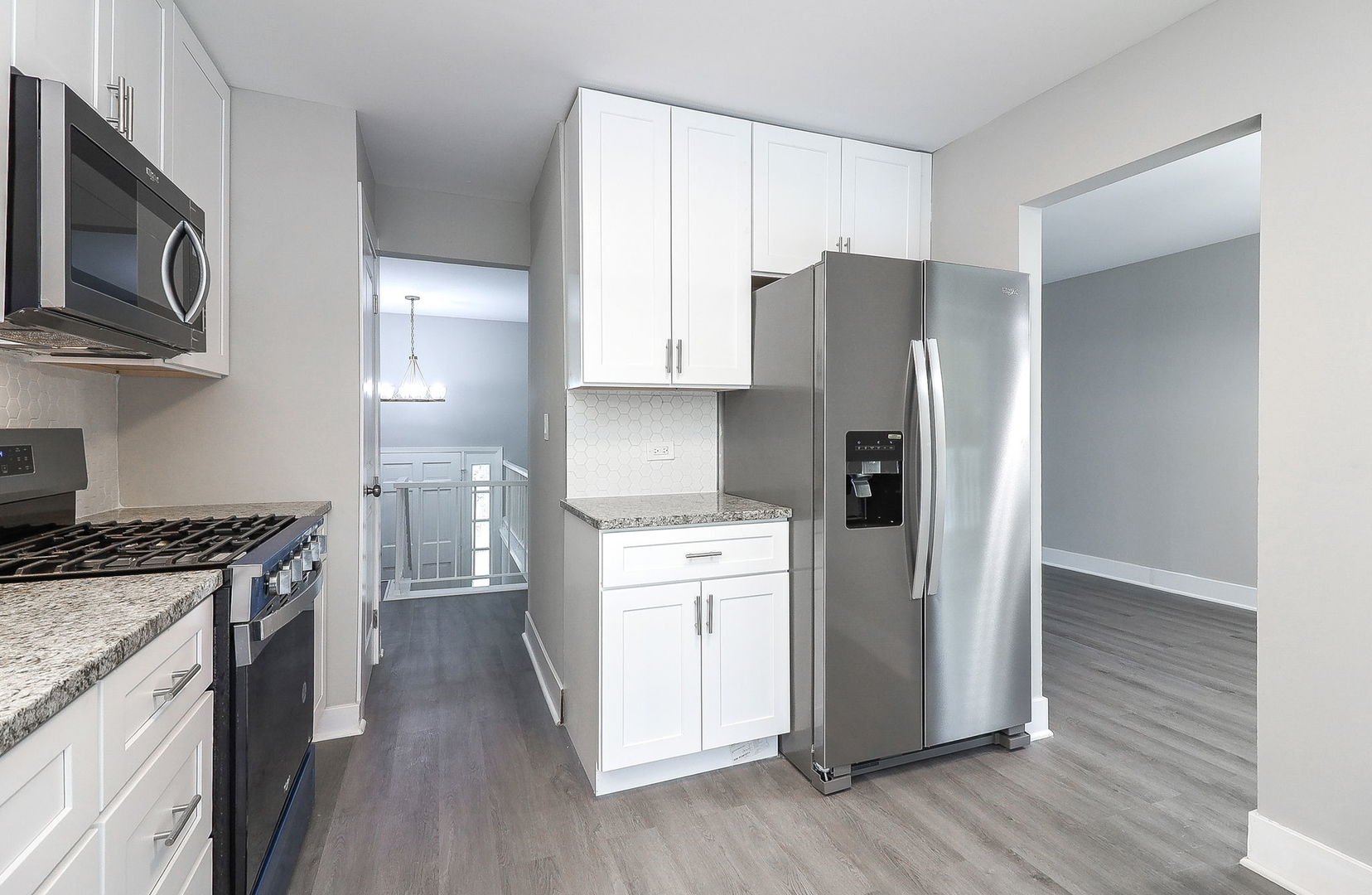 1914 Brookside Lane Hoffman Estates, IL 60169 - Photo 7 of 16 a kitchen with stainless steel appliances granite countertop a refrigerator stove and wooden floor
