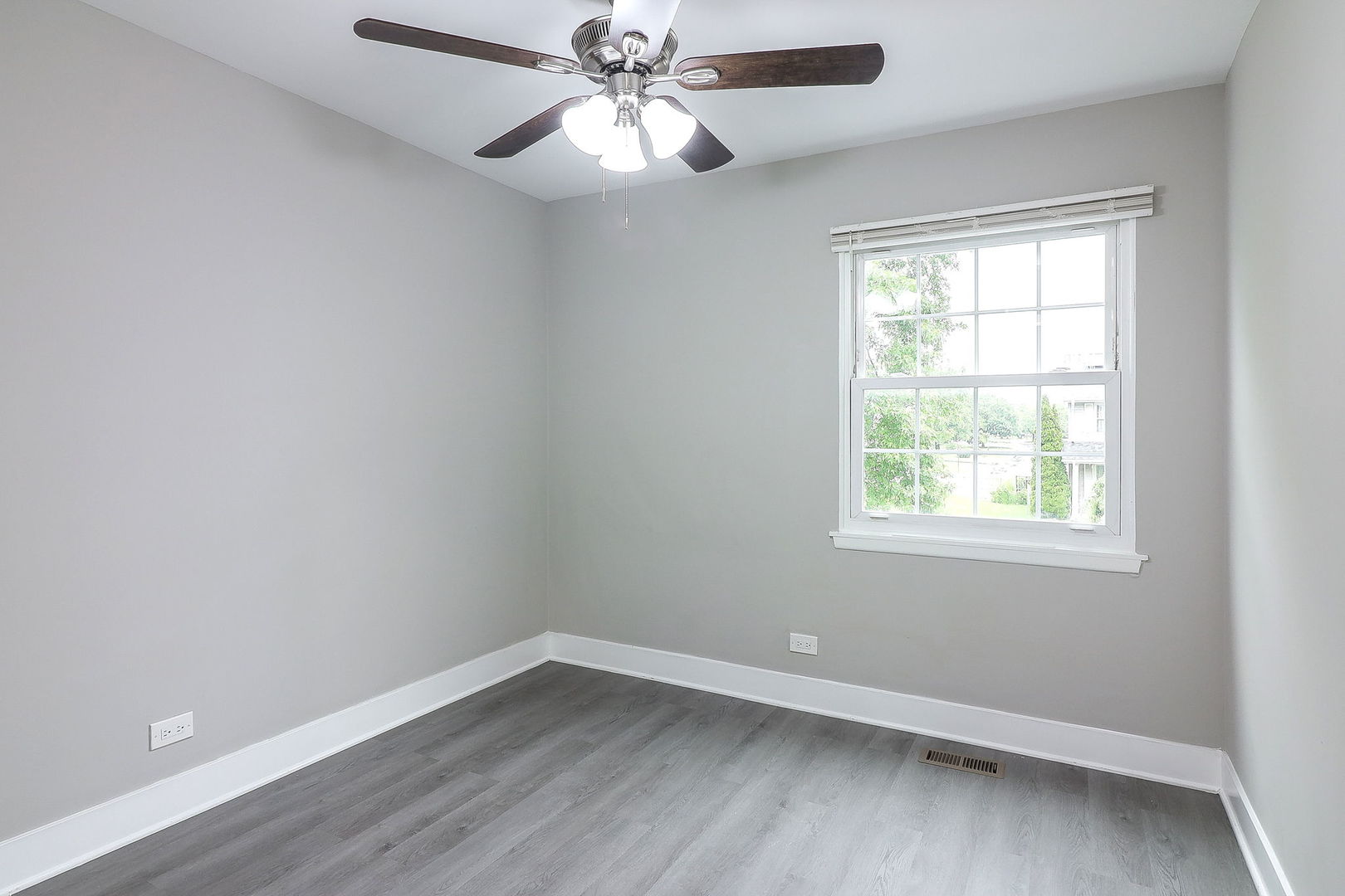 1914 Brookside Lane Hoffman Estates, IL 60169 - Photo 10 of 16 an empty room with a window and wooden floor