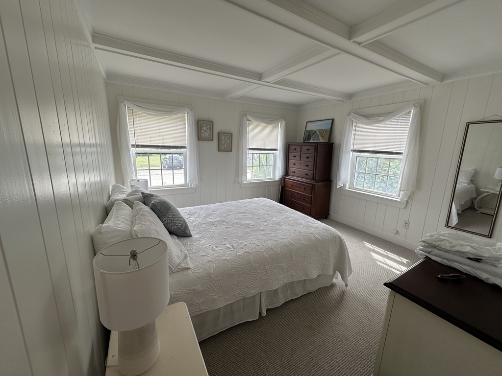 21 Stone Avenue Scituate, MA 02066 - Photo 13 of 20 a bedroom with a bed and a flat tv screen on a dresser