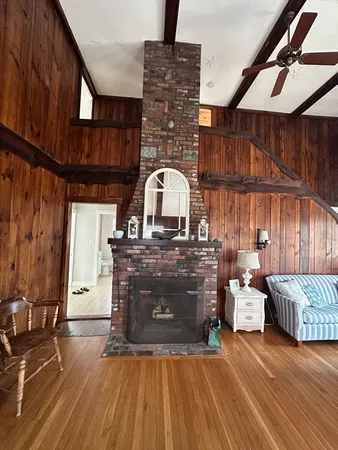a view of living room with furniture and fireplace