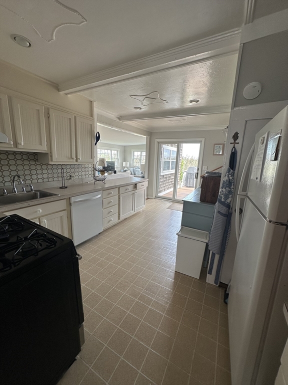 21 Stone Avenue Scituate, MA 02066 - Photo 16 of 20 a kitchen with granite countertop a refrigerator a sink a stove and cabinets