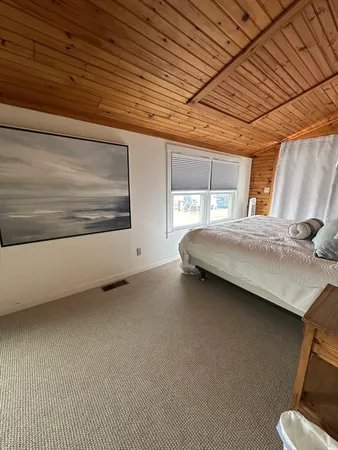 a bedroom with bed and window