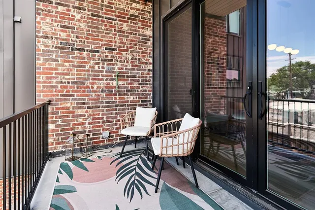 a view of a balcony with a couple of chairs