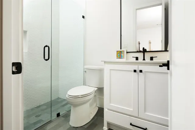 a bathroom with a sink a toilet and shower curtain