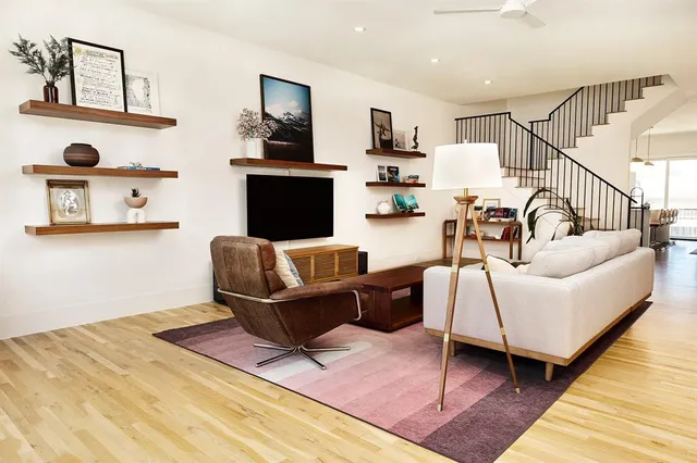 a living room with furniture and wooden floor