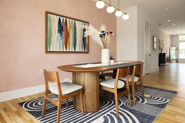 a view of a dining room with furniture and wooden floor