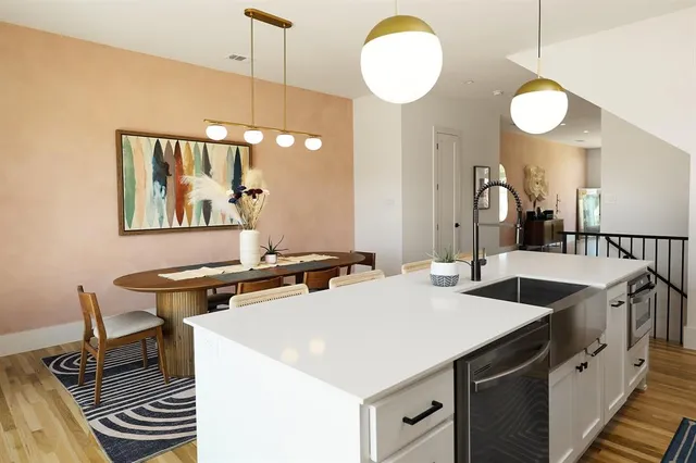 a kitchen with stainless steel appliances a stove a sink and a refrigerator