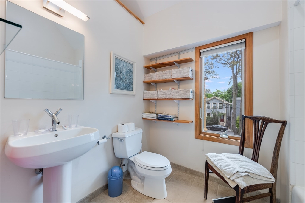 22 Decatur Street, Unit 20 Cambridge, MA 02139 - Photo 11 of 22 a bathroom with a sink toilet and a mirror
