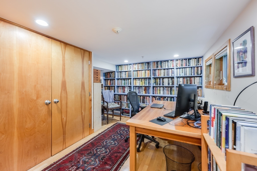 22 Decatur Street, Unit 20 Cambridge, MA 02139 - Photo 14 of 22 a room with furniture a rug and a book shelf