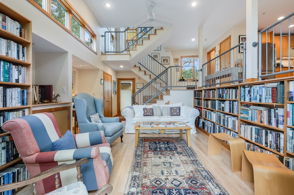 22 Decatur Street, Unit 20 Cambridge, MA 02139 - Photo 2 of 22 a living room with furniture lots of books and a book shelf