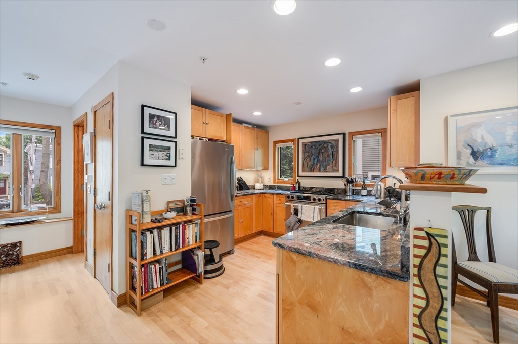 22 Decatur Street, Unit 20 Cambridge, MA 02139 - Photo 4 of 22 a large living room with large window and a flat screen tv