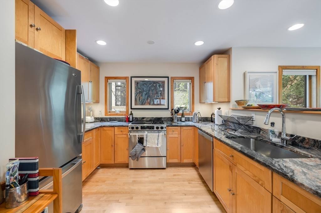 22 Decatur Street, Unit 20 Cambridge, MA 02139 - Photo 7 of 22 a large kitchen with granite countertop a sink stainless steel appliances and a counter top space