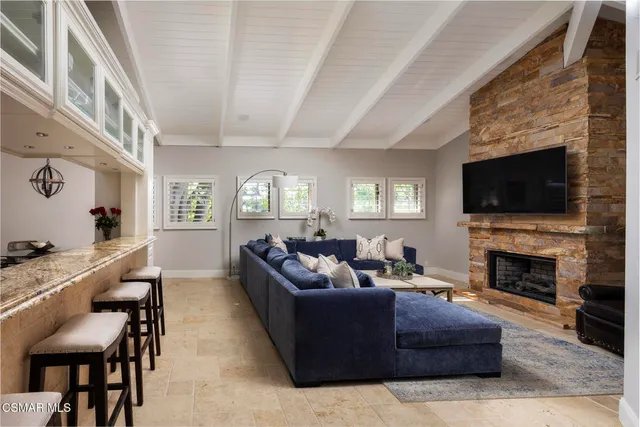 a spacious bathroom with a granite countertop sink a mirror and shower